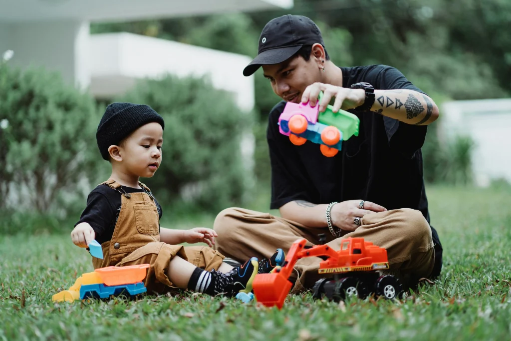 Father and Son Enjoying a Clean Yard | The Doodie Brothers Father and young son playing with toy trucks in a clean green yard after dog waste removal